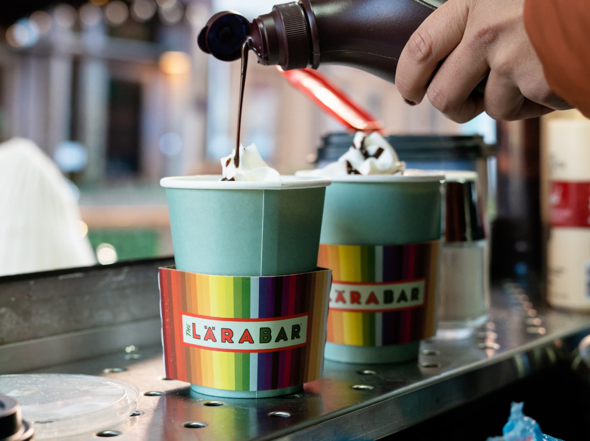 Two coffee cups with a Larabar wrapper